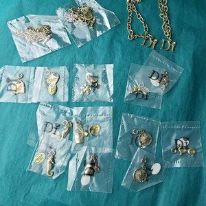 2/60$ Diamond International Lot of 4 bracelet and 12 charms gold tone